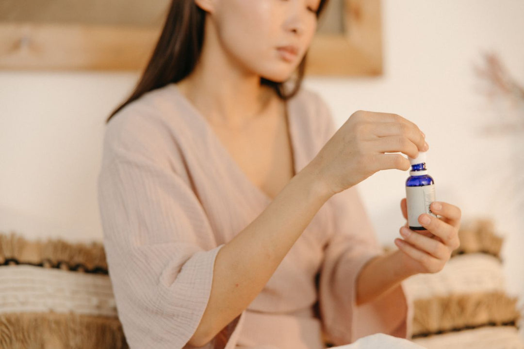 Woman holding blue bottle with a Matrixyl retinol serum