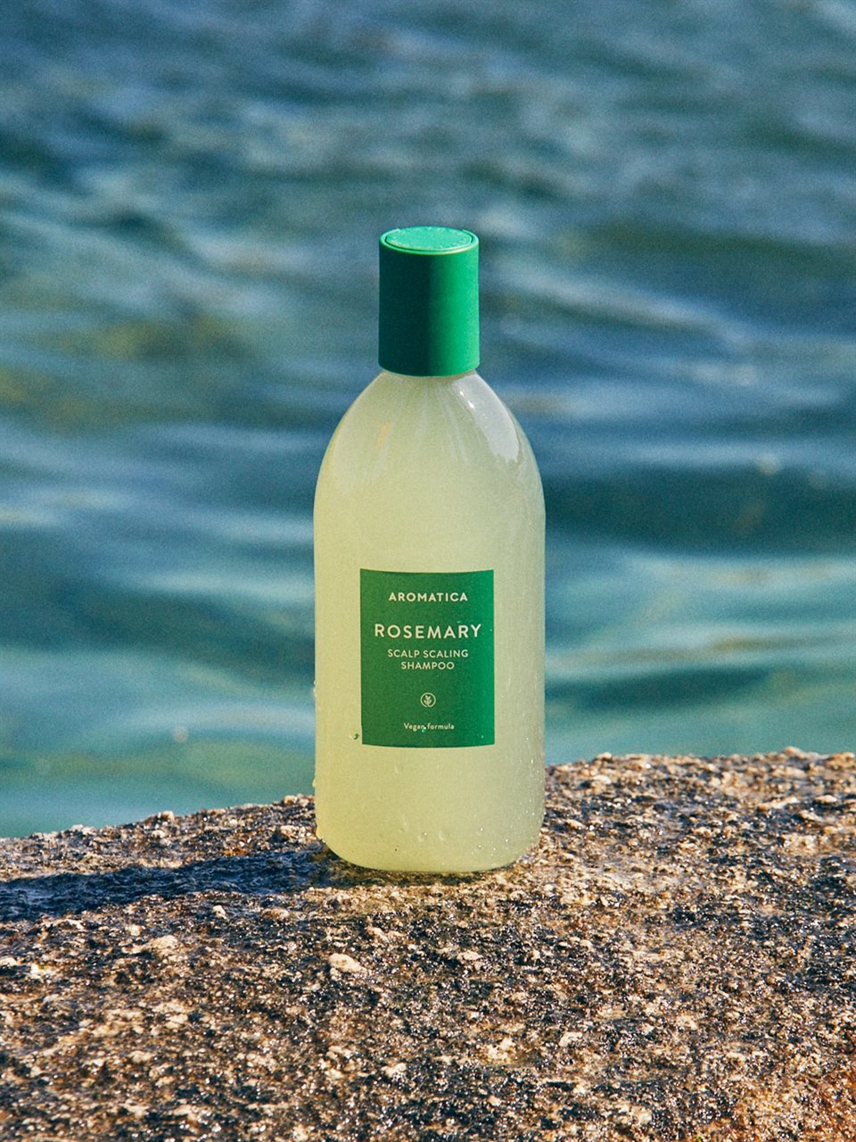 aromatica rosemary scalp scaling shampoo next to ocean
